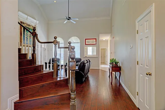 a view of a room with lots of wooden furniture and windows
