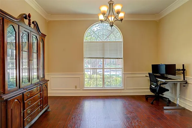 a view of a livingroom with workspace and a window