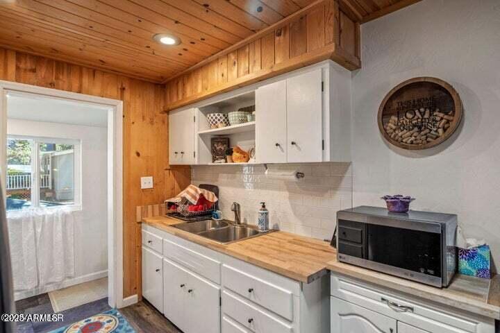 3355 Little Pine Drive Overgaard, AZ 85933 - Photo 15 of 26 a kitchen with white cabinets and a stove