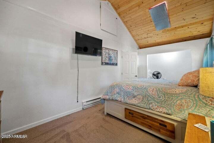 3355 Little Pine Drive Overgaard, AZ 85933 - Photo 19 of 26 a spacious bedroom with a bed and a flat screen tv