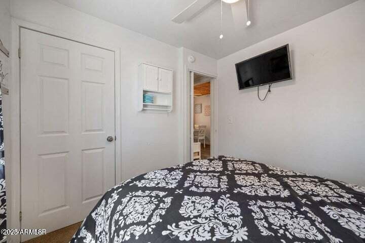 3355 Little Pine Drive Overgaard, AZ 85933 - Photo 22 of 26 a bedroom with a bed and a flat screen tv