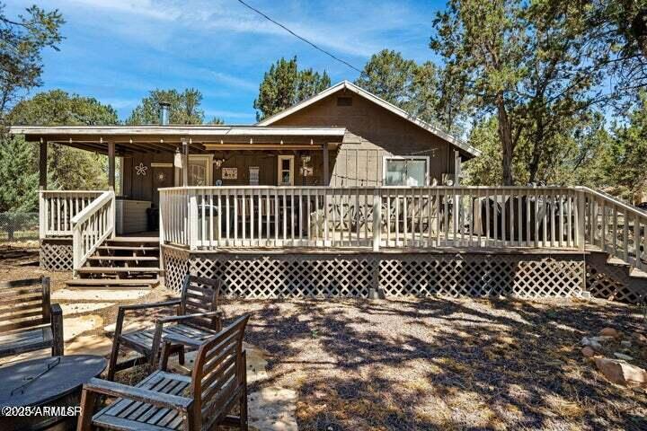 3355 Little Pine Drive Overgaard, AZ 85933 - Photo 3 of 26 a view of a wooden deck with wooden fence