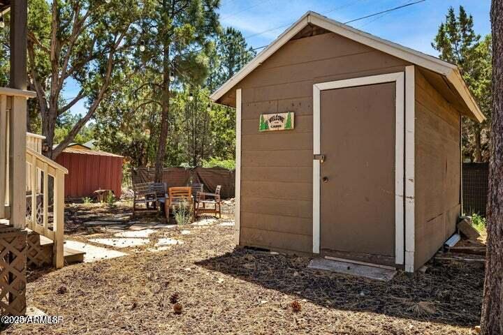 3355 Little Pine Drive Overgaard, AZ 85933 - Photo 4 of 26 a backyard of a house with table and chairs with wooden fence