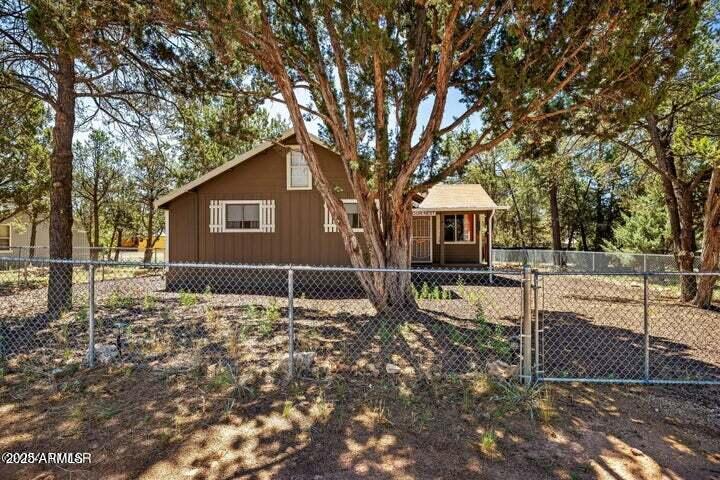 3355 Little Pine Drive Overgaard, AZ 85933 - Photo 9 of 26 a front view of a house with garden