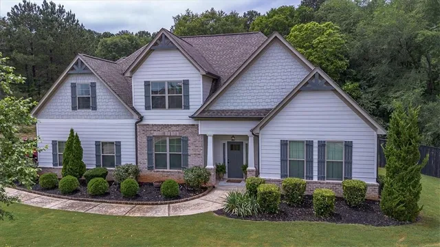 a front view of a house with garden