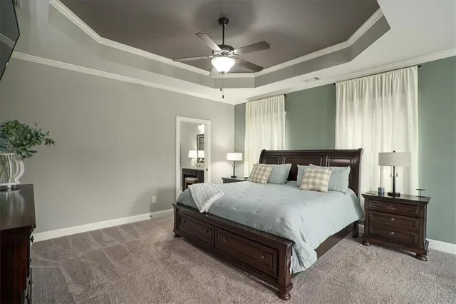 a spacious bedroom with a bed and a chandelier