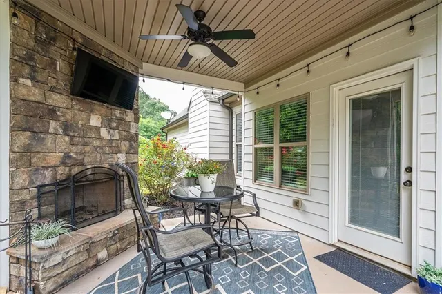 a patio with yard glass top table and chairs