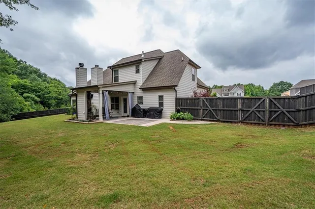 an aerial view of a house with garden space and street view