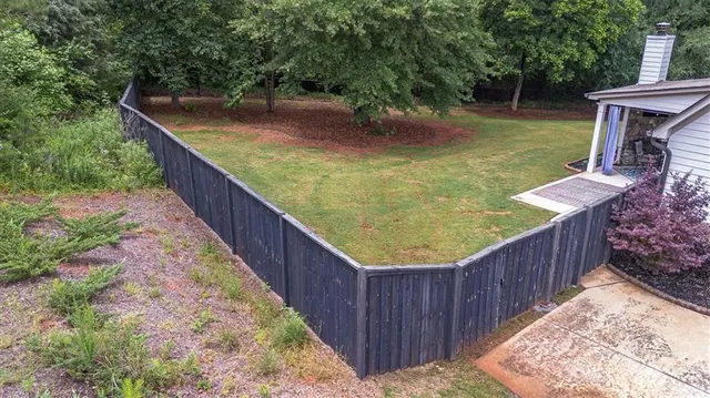 an aerial view of a house with swimming pool and outdoor seating