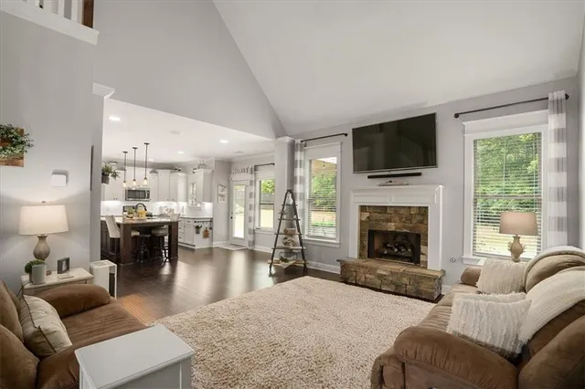 a living room with furniture a fireplace and a flat screen tv