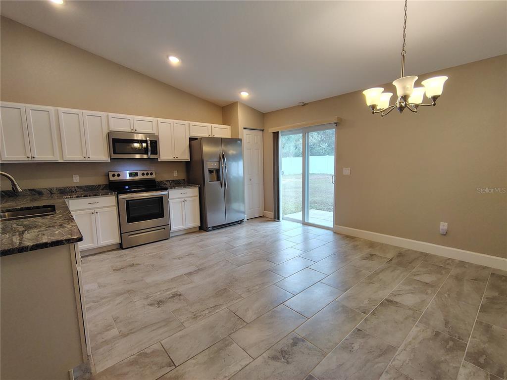 13093 Southwest 35th Circle Ocala, FL 34473 - Photo 4 of 15 a view of a kitchen with a sink and stainless steel appliances