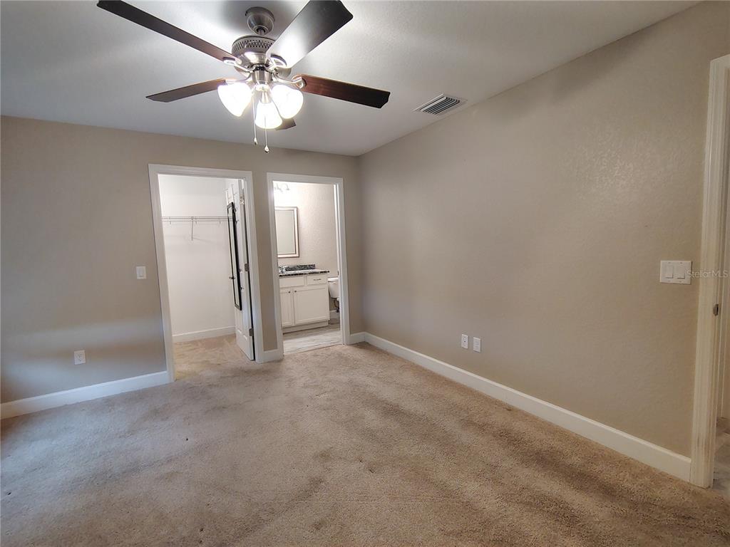 13093 Southwest 35th Circle Ocala, FL 34473 - Photo 5 of 15 an empty room with chandelier fan and windows