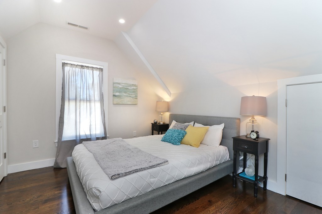 59 Mozart Street, Unit 2 Boston, MA 02130 - Photo 14 of 21 a bedroom with a bed and wooden floor