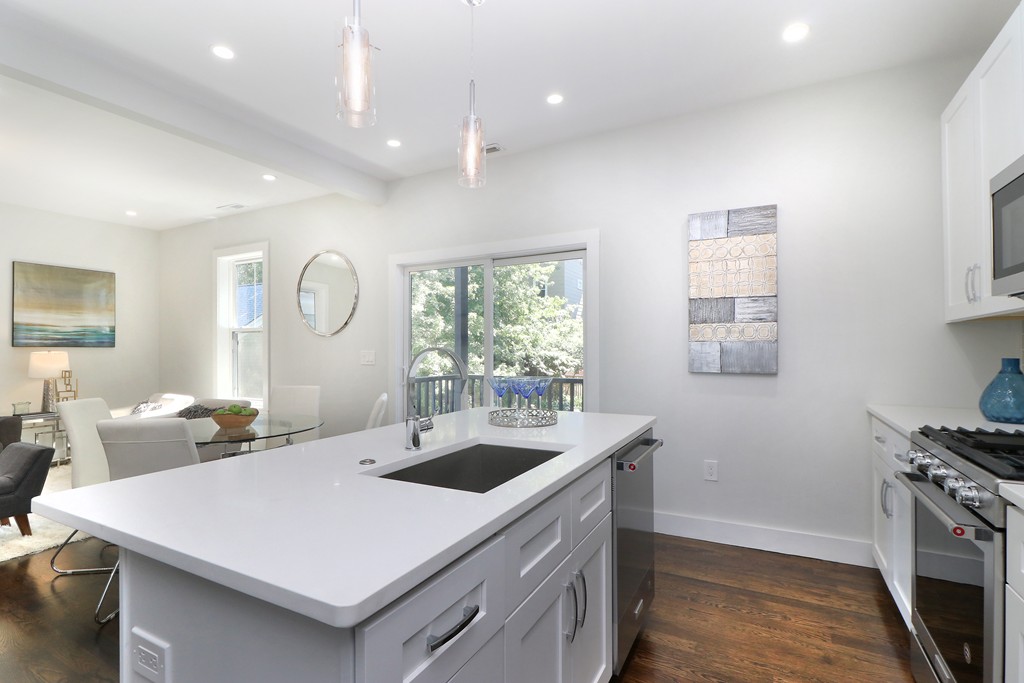 59 Mozart Street, Unit 2 Boston, MA 02130 - Photo 20 of 21 a kitchen with a sink a stove and chairs