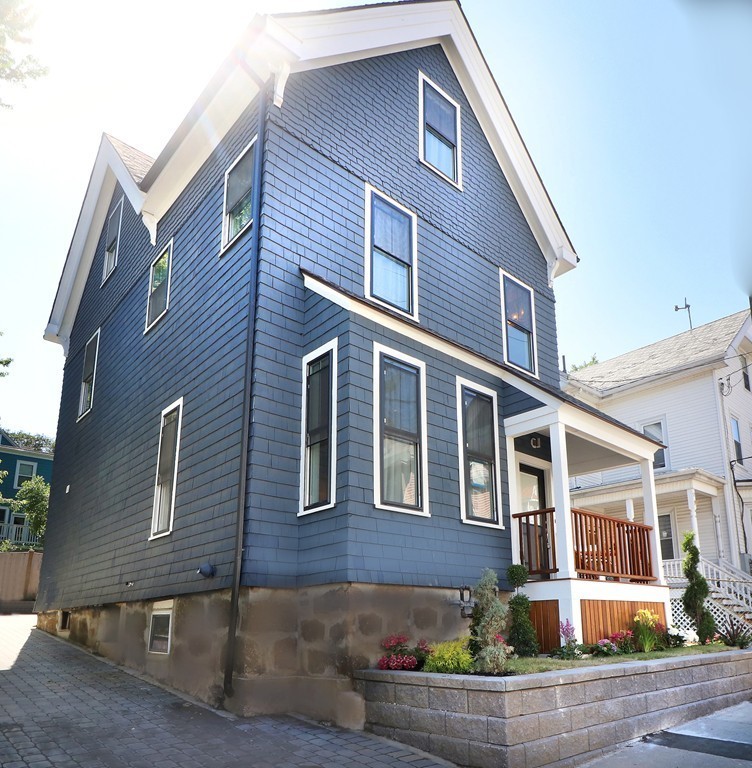 59 Mozart Street, Unit 2 Boston, MA 02130 - Photo 3 of 21 a front view of a house with a yard