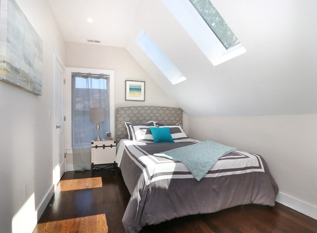 59 Mozart Street, Unit 2 Boston, MA 02130 - Photo 5 of 21 a bedroom with a bed and a night stand