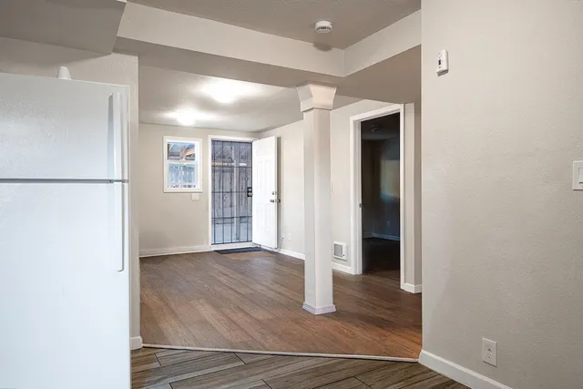 a view of an empty room with closet and a window