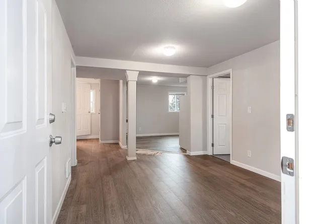 a view of a hallway with wooden floor