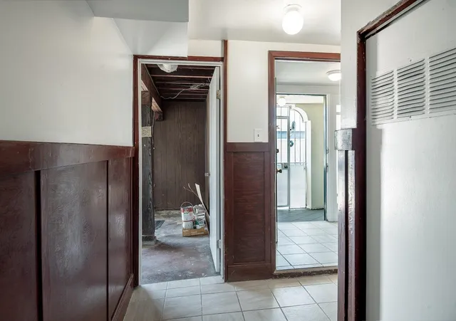 a view of a walk in closet and a bathroom