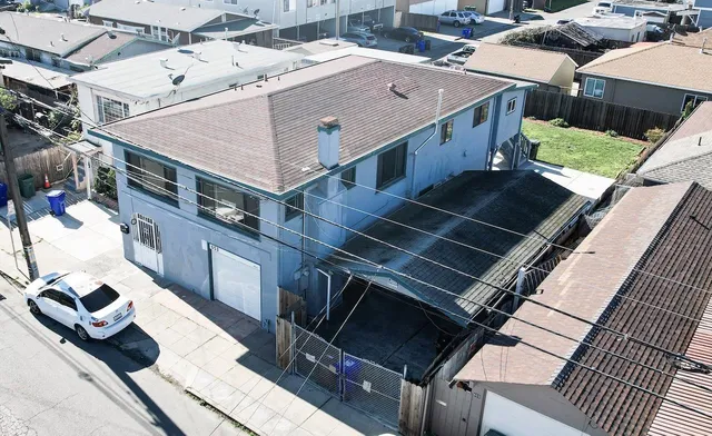 an aerial view of a house with balcony and garage