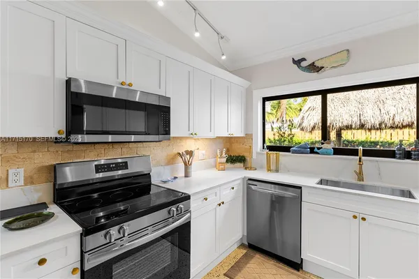 a kitchen with a microwave and a white cabinets