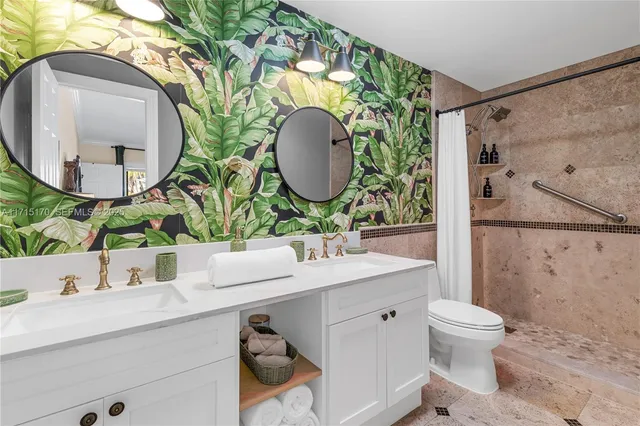 a white toilet sitting next to a bath tub