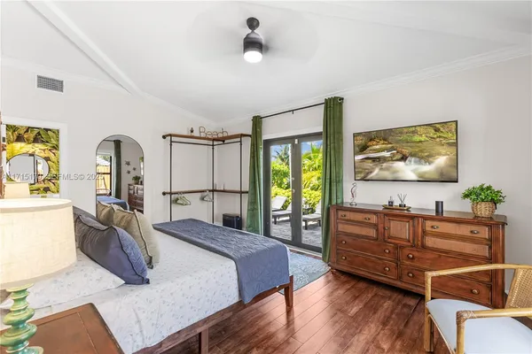 a bedroom with a large bed and a large window