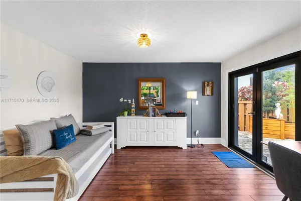 a living room with furniture and a wooden floor