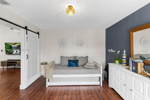a living room with furniture a ceiling fan and a window