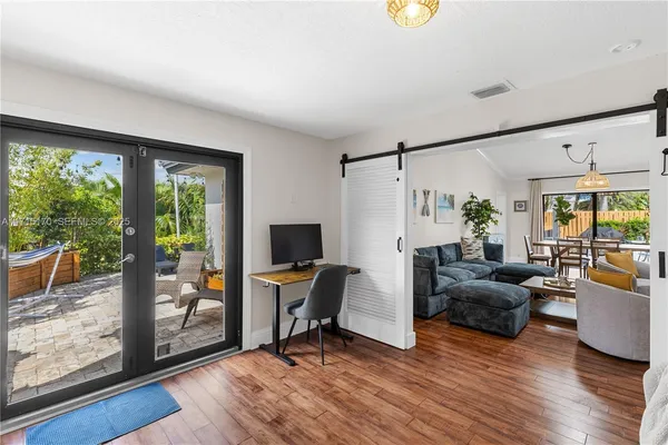 a view of a workspace with furniture and a window