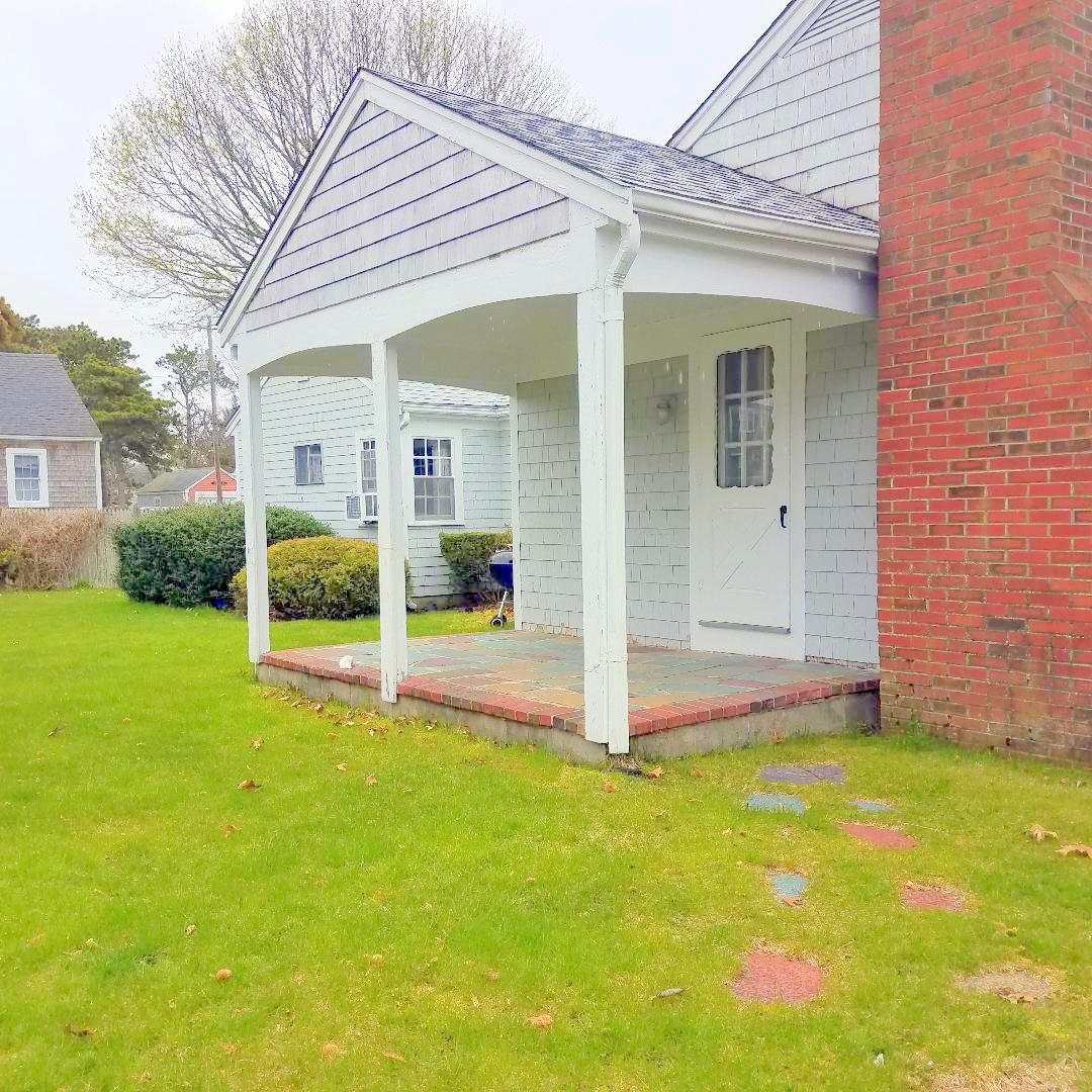 15 Osborne Road Harwich, MA 02671 - Photo 3 of 32 a view of a house with backyard and porch
