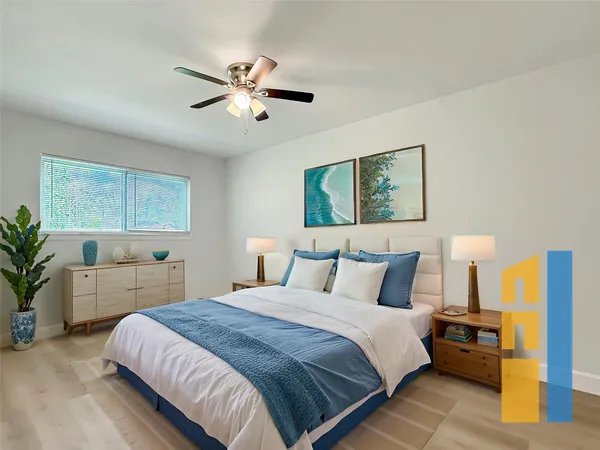 a bedroom with a large bed and a chandelier