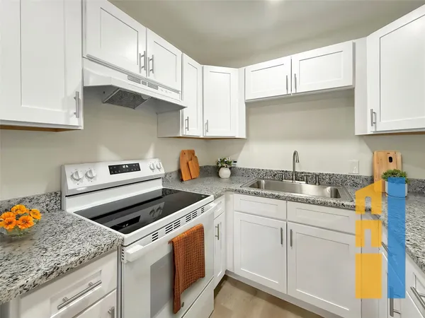 a kitchen with appliances cabinets and a sink