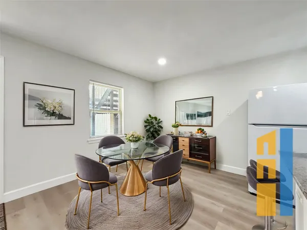 a dining room with furniture and window