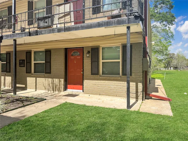 a view of a building with a yard front of house