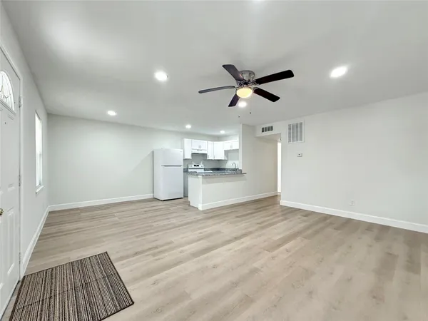 a view of a kitchen with a sink and a refrigerator
