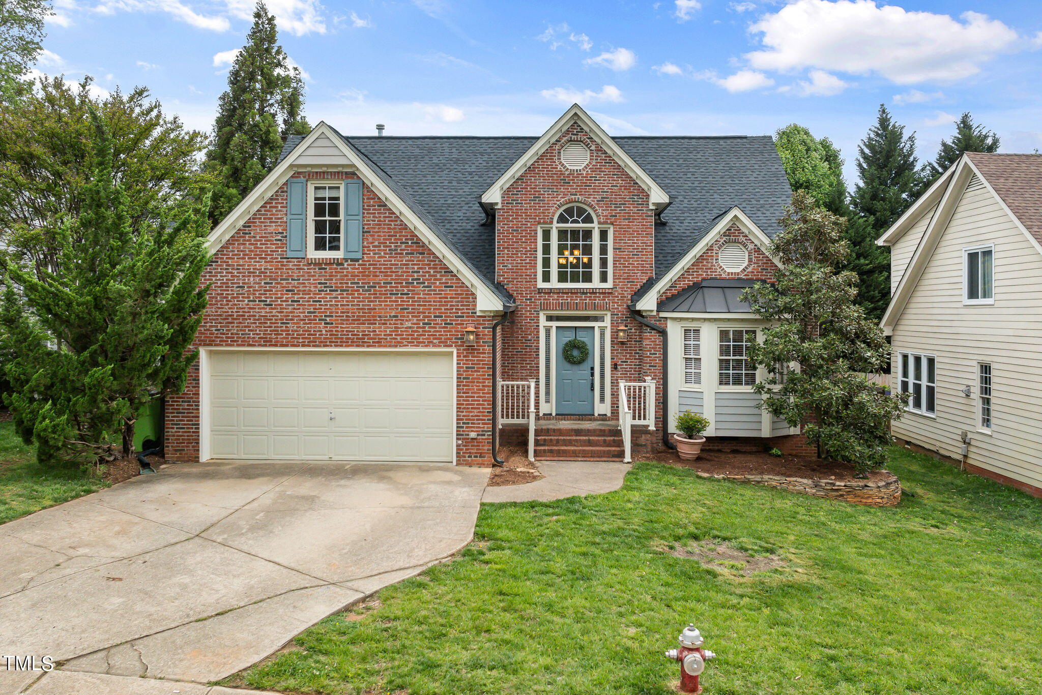 8673 Harps Mill Road Raleigh, NC 27615 - Photo 1 of 38 a front view of a house with a garden