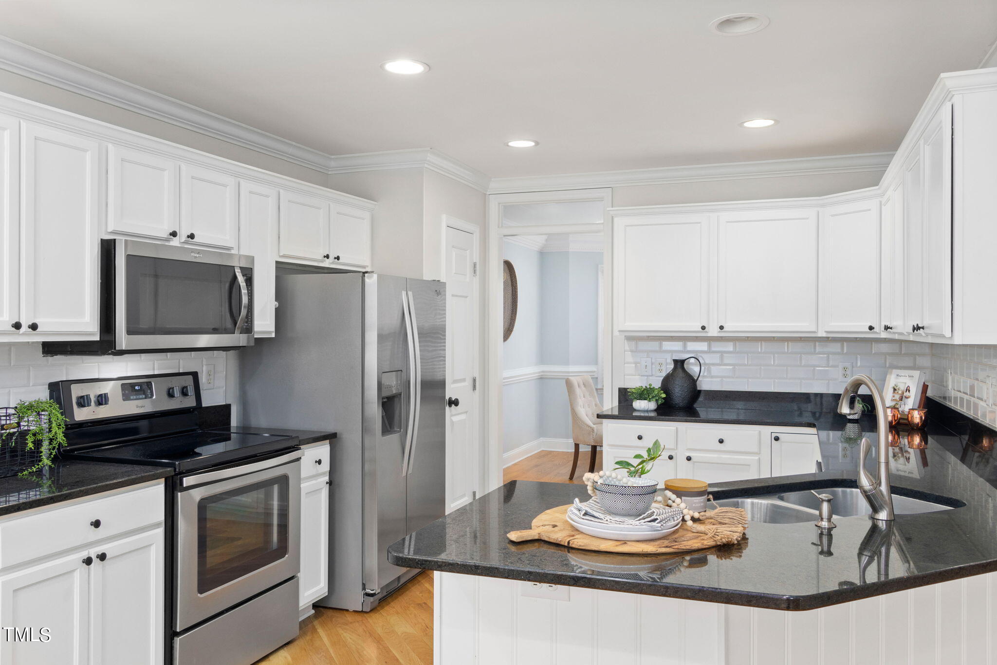 8673 Harps Mill Road Raleigh, NC 27615 - Photo 12 of 38 a kitchen with stainless steel appliances granite countertop a sink a stove and cabinets