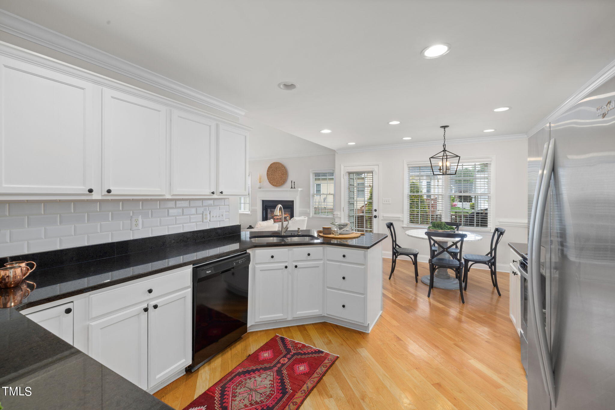 8673 Harps Mill Road Raleigh, NC 27615 - Photo 13 of 38 a kitchen with granite countertop sink window and white stainless steel appliances