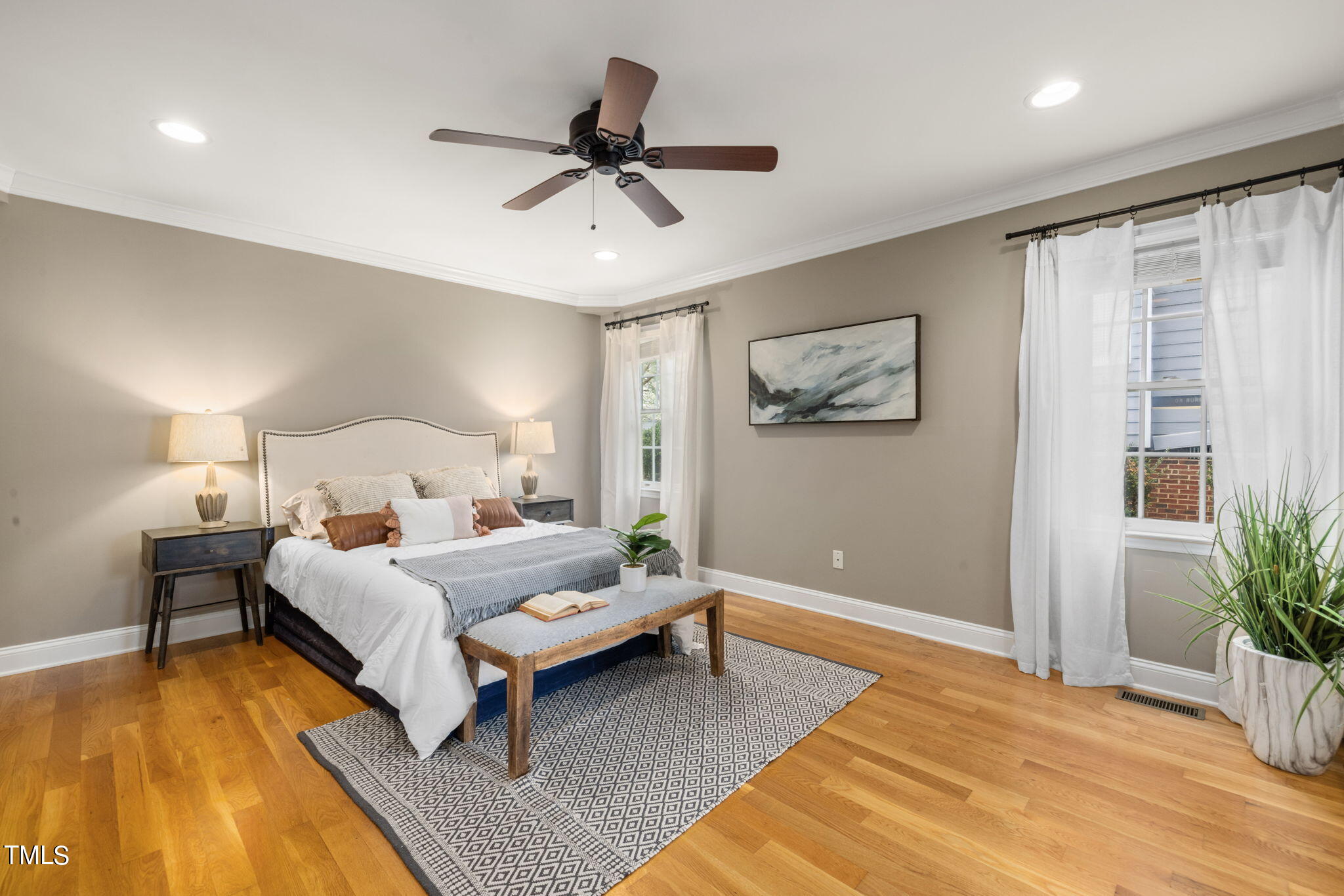 8673 Harps Mill Road Raleigh, NC 27615 - Photo 17 of 38 a bedroom with a bed lamp and a potted plant