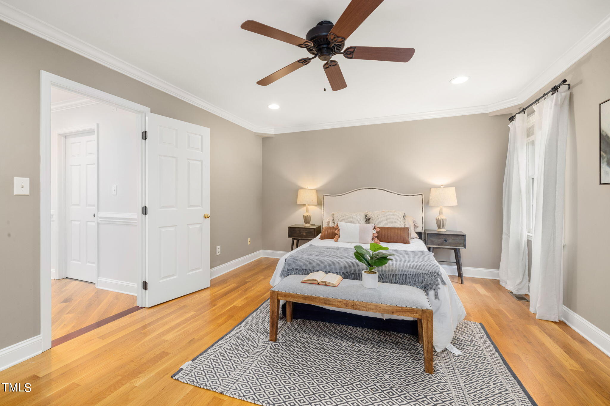 8673 Harps Mill Road Raleigh, NC 27615 - Photo 18 of 38 a bedroom with a bed lamp and a rug