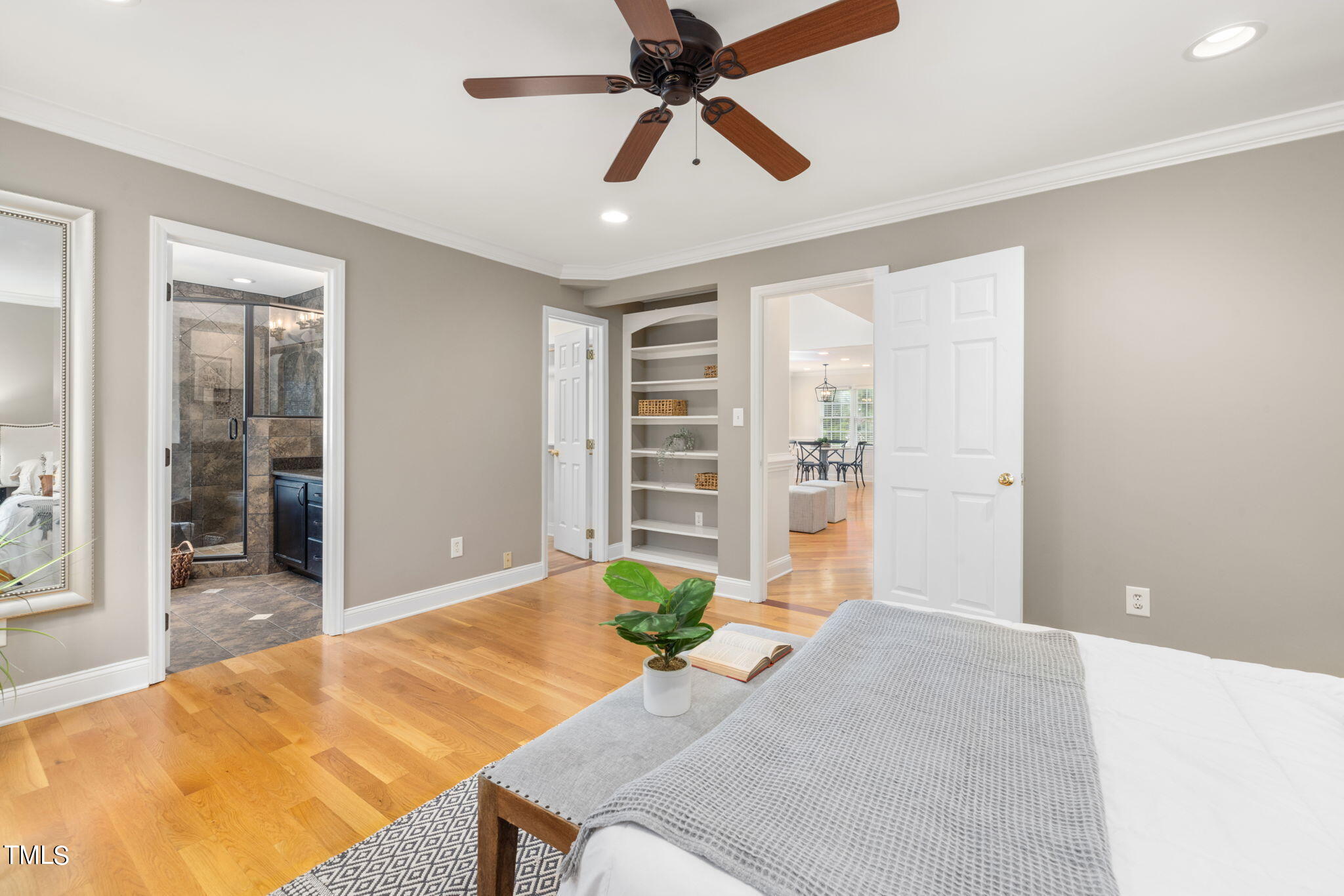 8673 Harps Mill Road Raleigh, NC 27615 - Photo 19 of 38 a bedroom with a bed and a chandelier