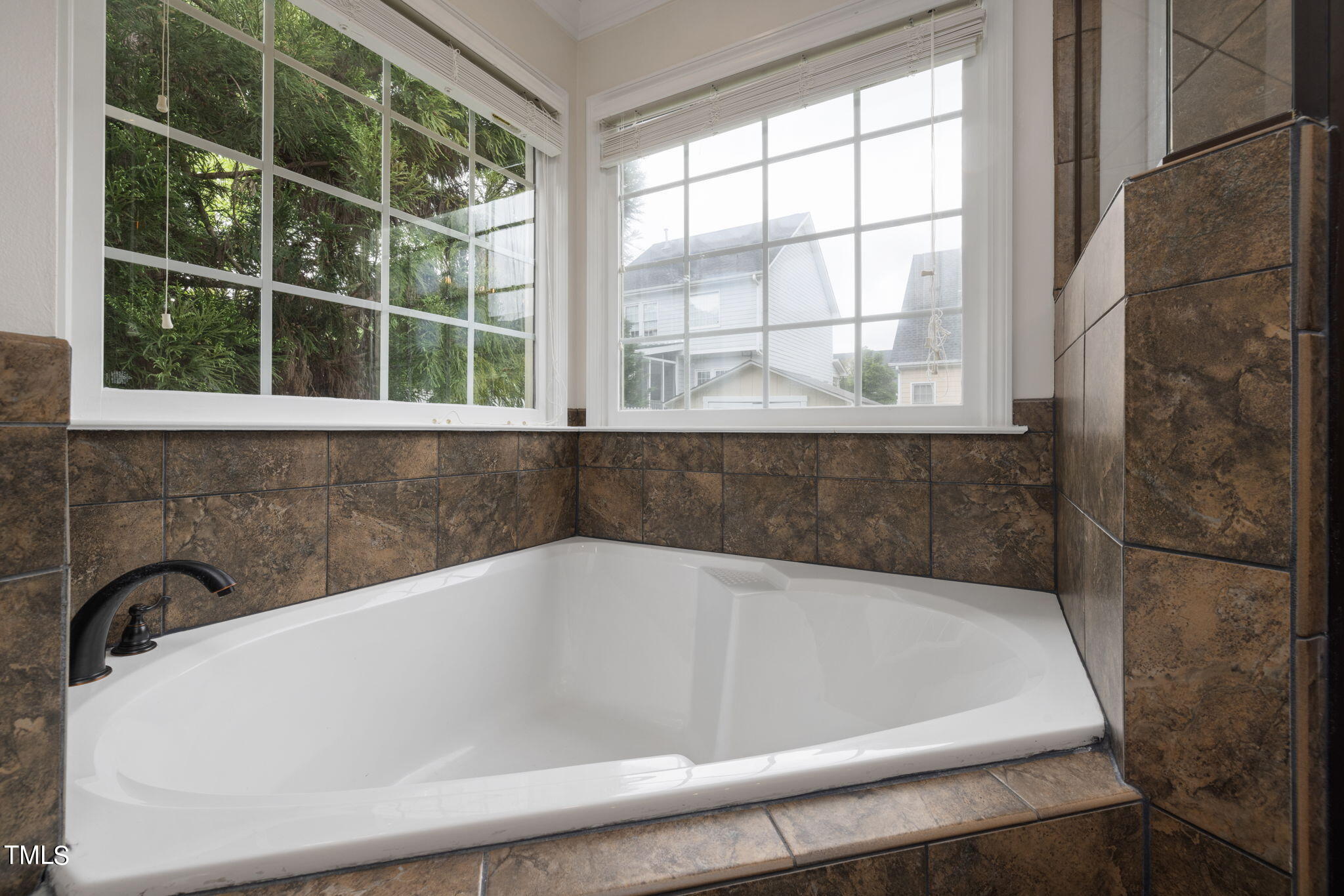 8673 Harps Mill Road Raleigh, NC 27615 - Photo 24 of 38 a bath tub sitting next to a window