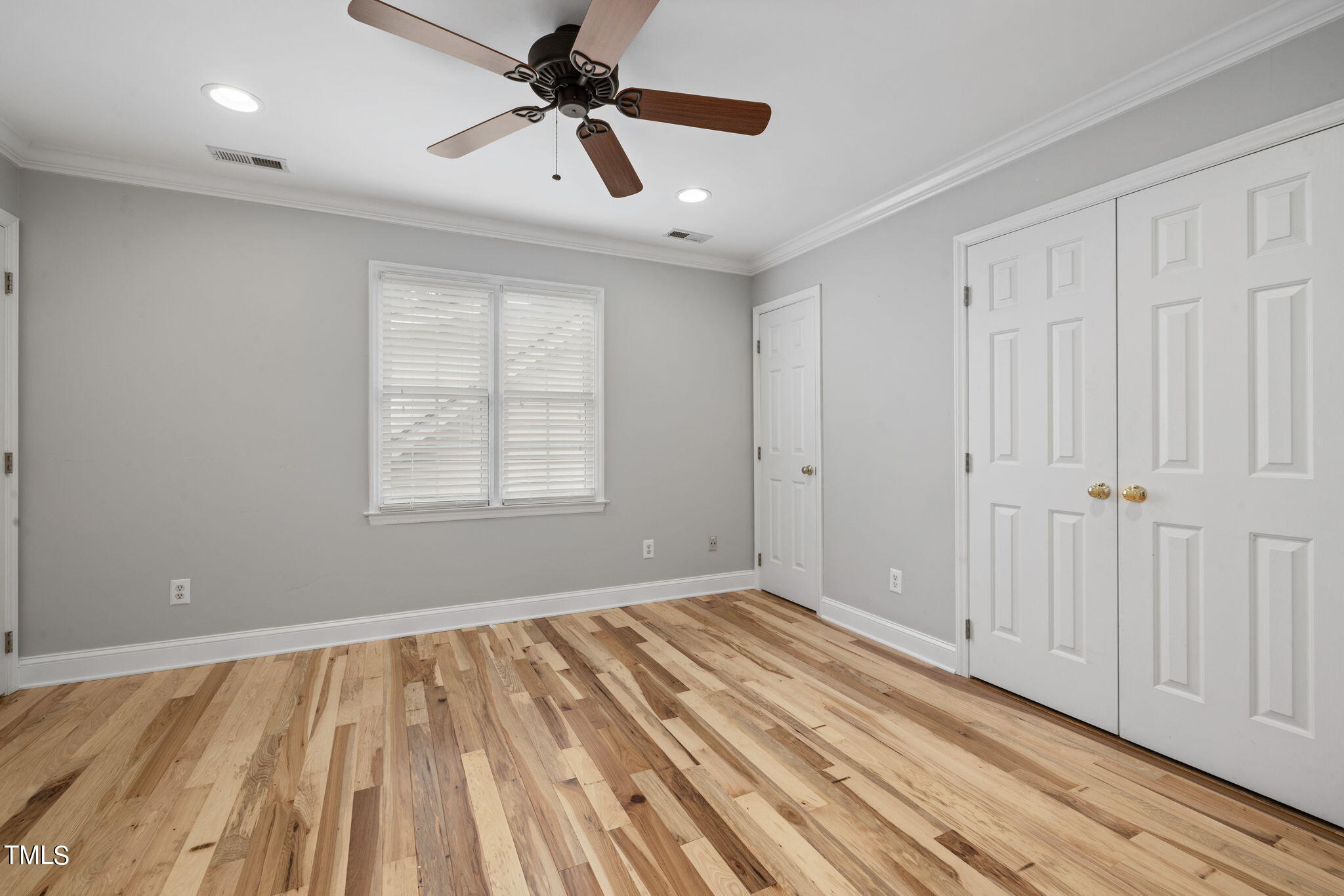 8673 Harps Mill Road Raleigh, NC 27615 - Photo 29 of 38 wooden floor in an empty room with a window