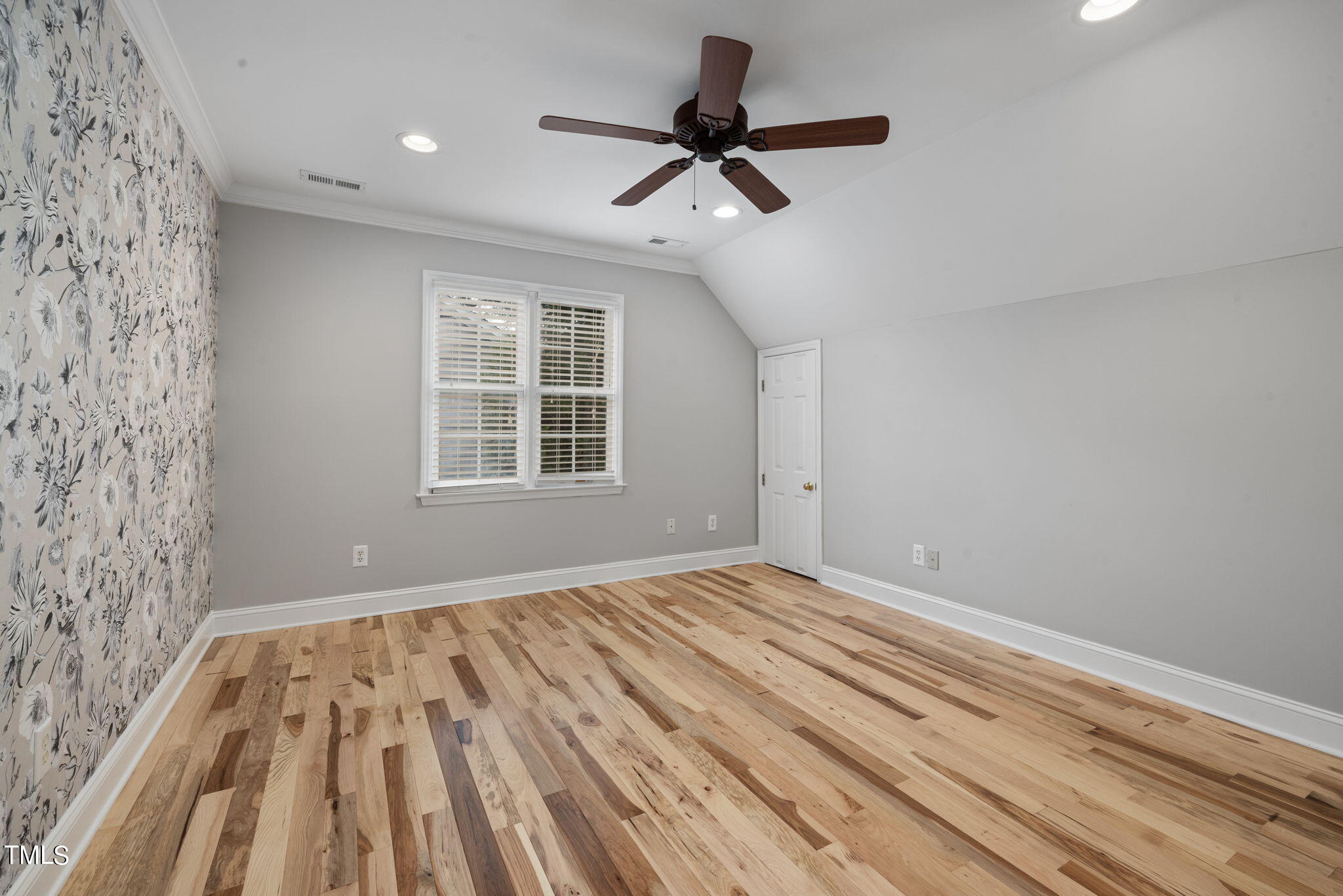 8673 Harps Mill Road Raleigh, NC 27615 - Photo 30 of 38 a view of empty room with wooden floor and window