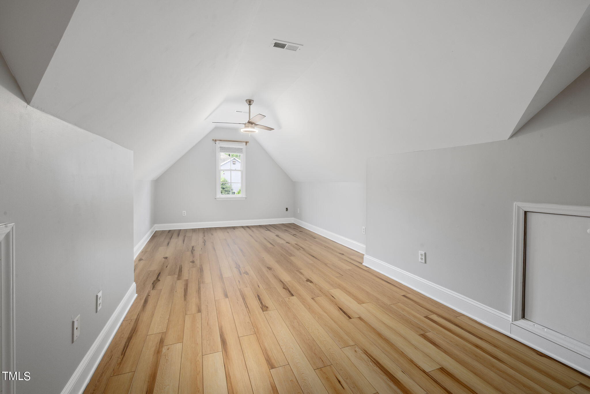 8673 Harps Mill Road Raleigh, NC 27615 - Photo 32 of 38 wooden floor in an empty room with a window