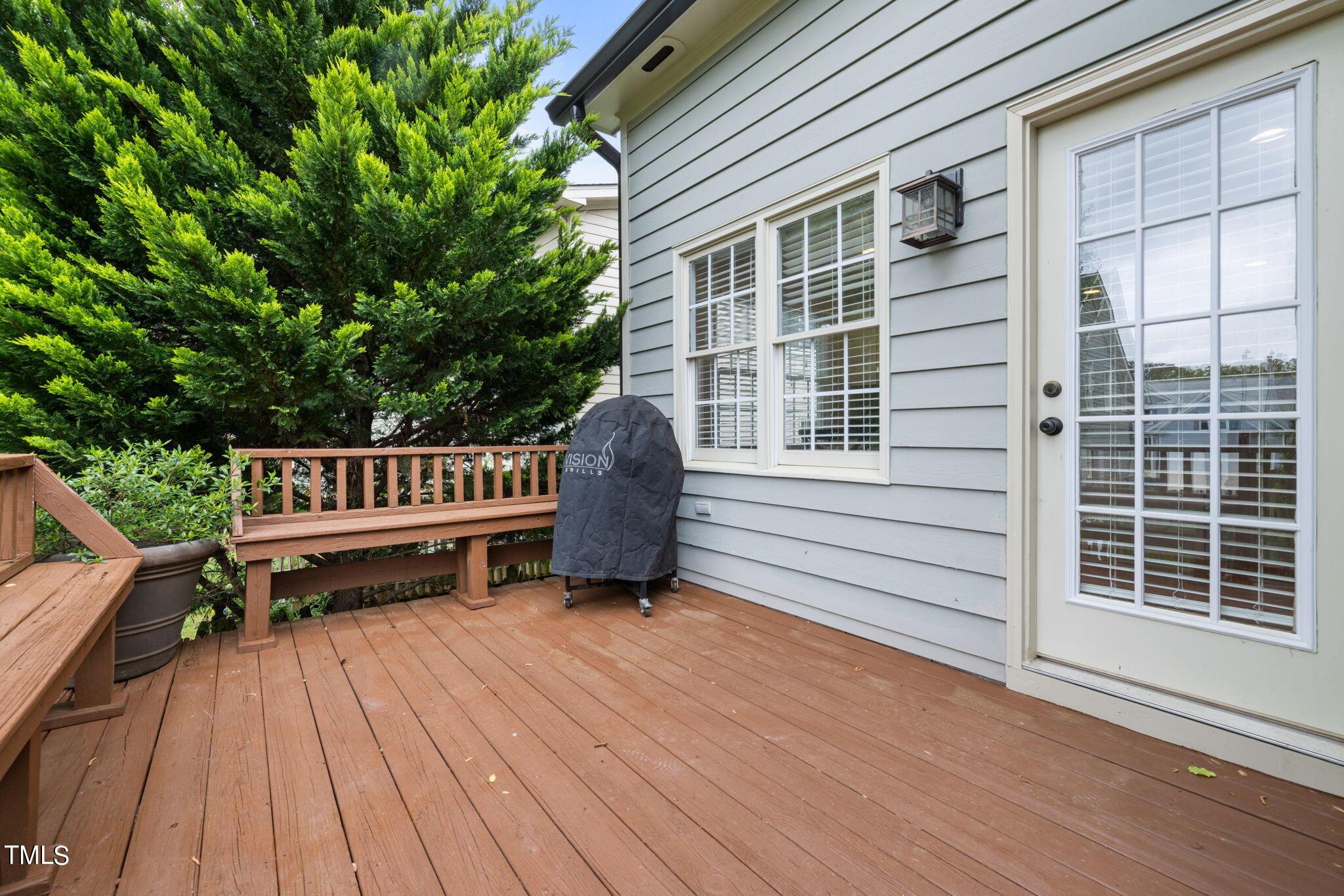 8673 Harps Mill Road Raleigh, NC 27615 - Photo 34 of 38 a roof deck with a wooden floor and fence