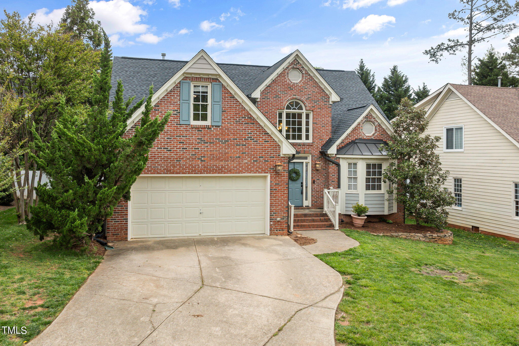 8673 Harps Mill Road Raleigh, NC 27615 - Photo 37 of 38 a front view of a house with a yard and garage