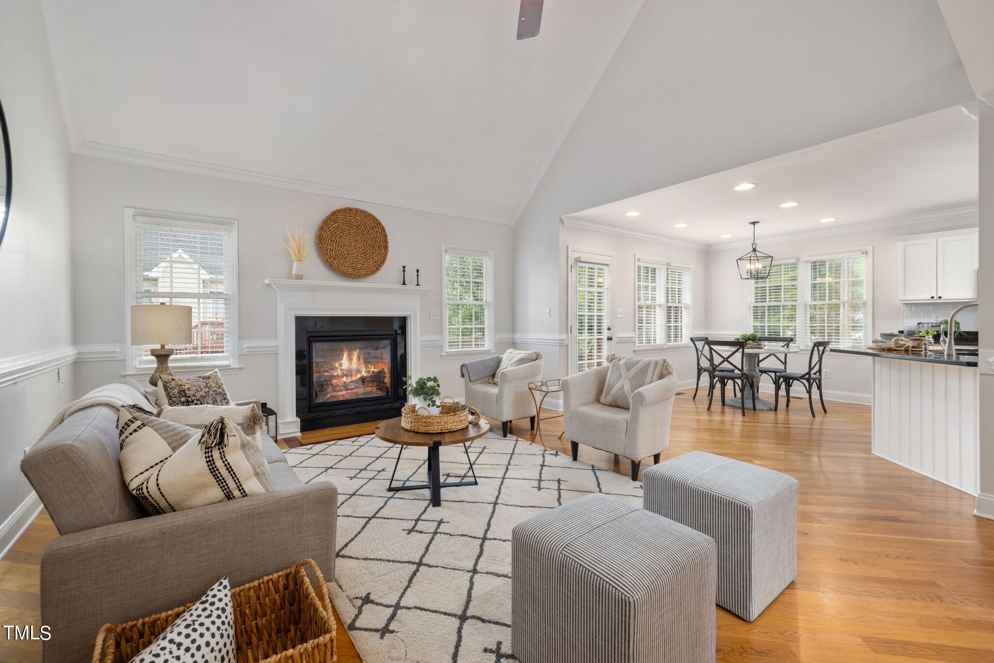 8673 Harps Mill Road Raleigh, NC 27615 - Photo 7 of 38 a living room with furniture dining table a fireplace and a table