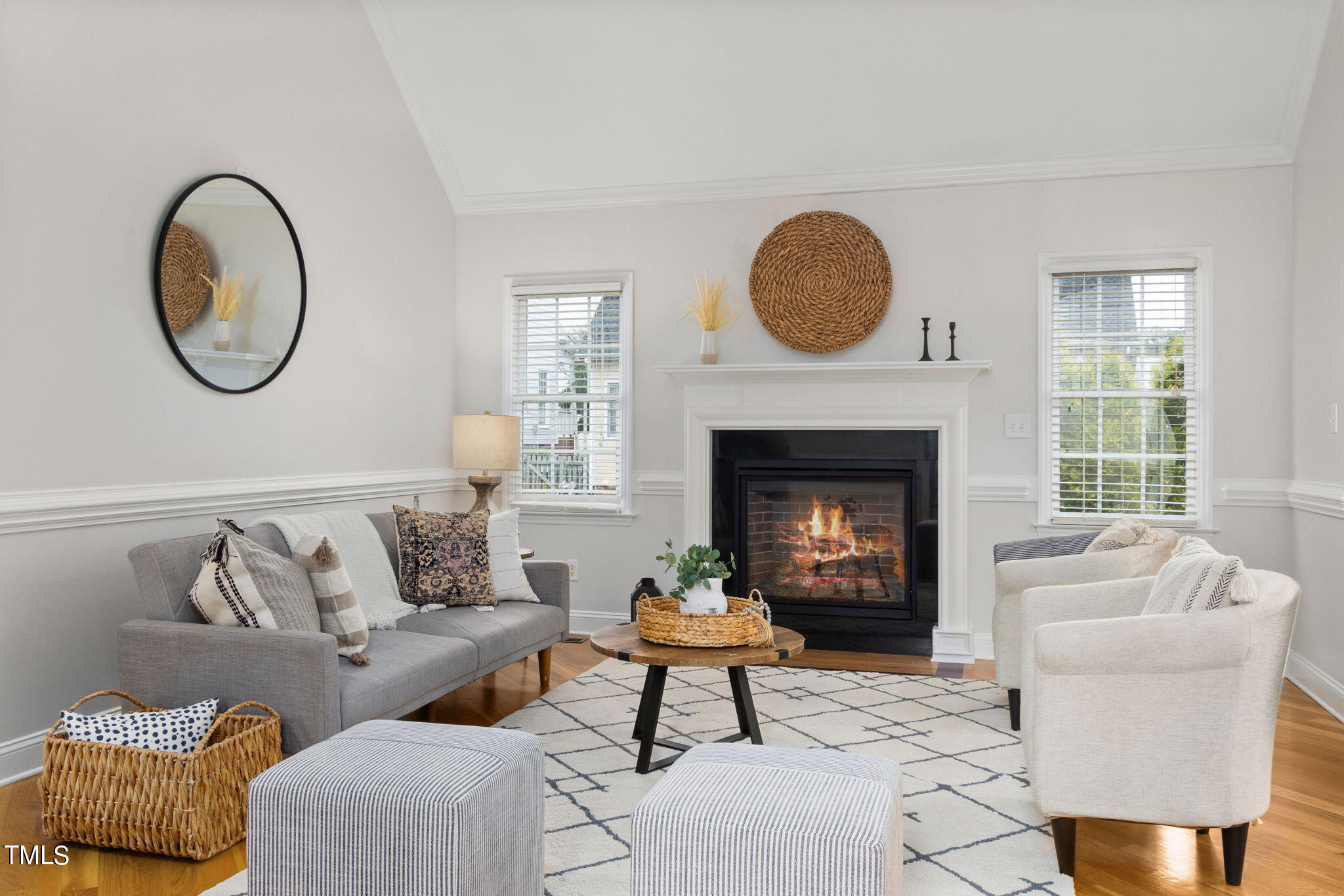 8673 Harps Mill Road Raleigh, NC 27615 - Photo 9 of 38 a living room with furniture a rug a fireplace and a large window